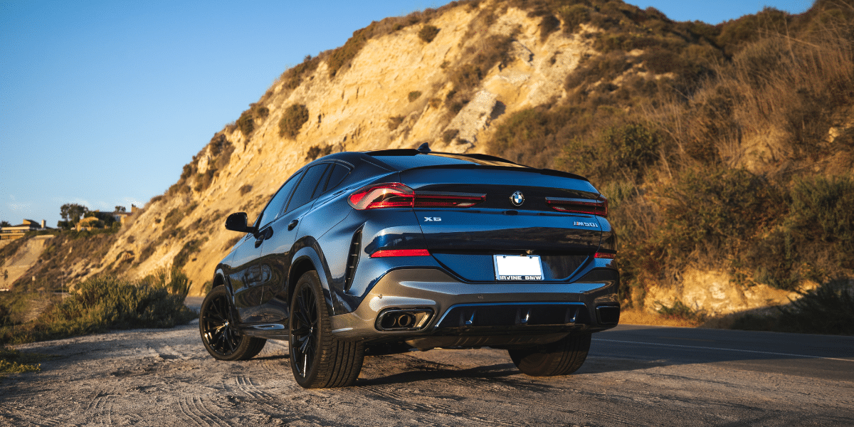 rear view of bmw x6 on a dirt road