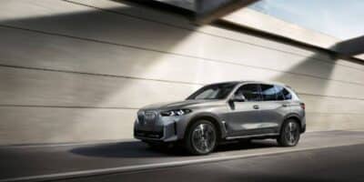 The bmw x5 hybrid driving through a tunnel on the highway.