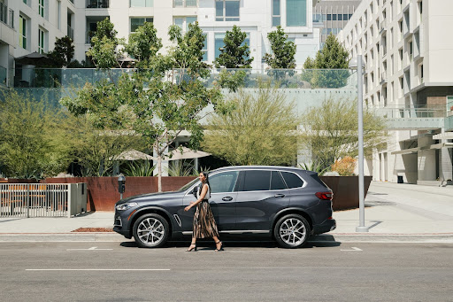 A woman walking out of her bmw x5.