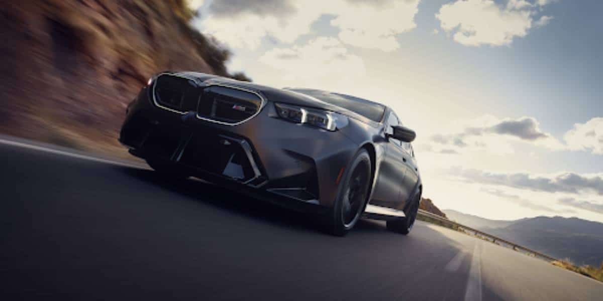 A sedan with BMW run flat tires driving down a highway.